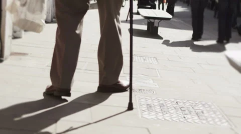 Low angle view of elderly person walking through uk commercial area Stock-Footage 32963177