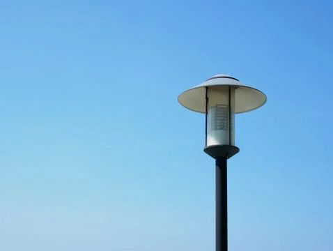 Low Angle View of Electric Lighting Post Against Clear Blue Sky Stock Photos