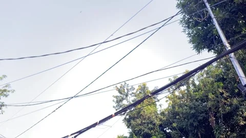 Low angle view of electric poles and cables under dramatic cloudy sky Video stock 328338409