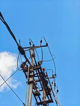Low Angle View of Electric Utility Pole with Power Lines Against Blue Sky Stock Photos