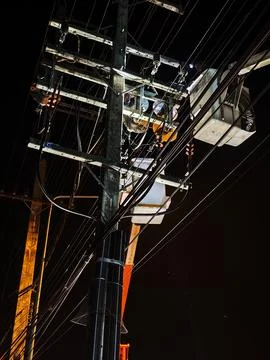 Low angle view of electrical lineman team working on hydraulic bucket truck. Stock Photos