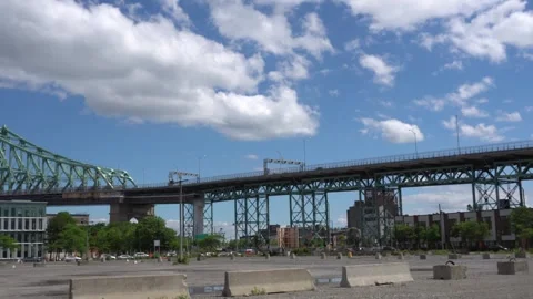Low-angle view of an elevated metal bridge spanning an industrial urban area 스톡 동영상 335353563