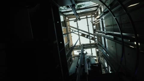 Low angle view of elevator car moving down industrial shaft construction. Stock Footage 334607565
