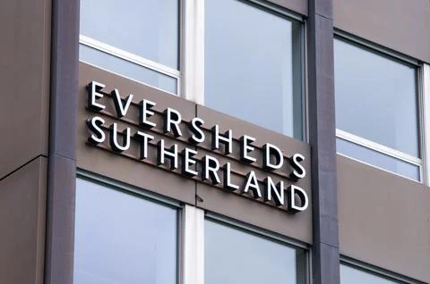 Low angle view of the Eversheds Sutherland law firm sign on a modern buildi.. Stock Photos
