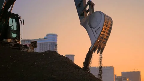 Low angle view of excavator flipping the bucket with soil Stock Footage 225093594