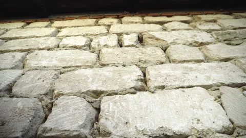 Low angle view of an exposed limestone house wall beneath wooden eaves and .. 動画素材 345979596