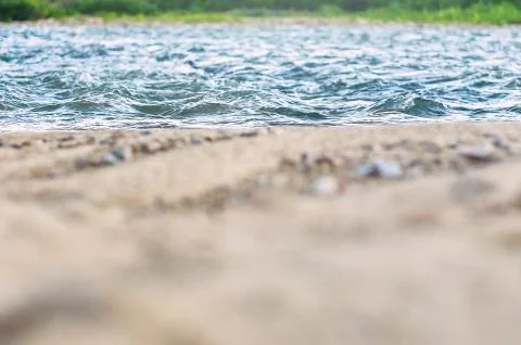 Low Angle View of Fast River Waves, Wet Coarse Sand, Pebble. Stock Photos
