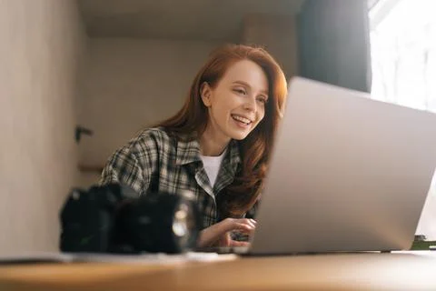 Low-angle view of female editor working in home photo studio, retouching bad Stock Photos