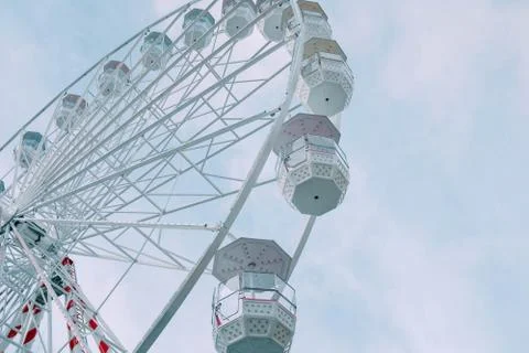 Low angle view of the Ferris Wheel carousel during daytime under a blue sky Stock Photos