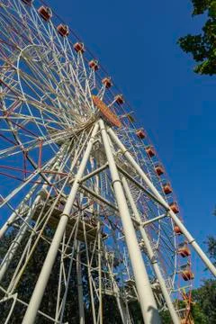 Low angle view of ferris wheel against blue sky Stock Photos