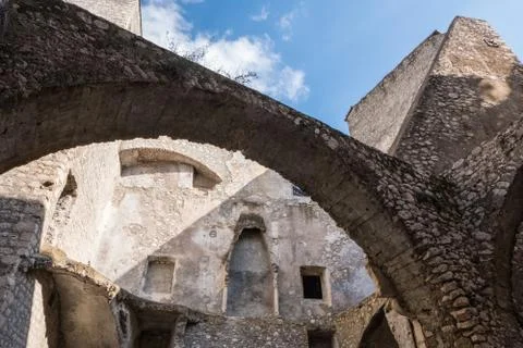 Low angle view of a feudal stone wall castle with blue sky background. Stock Photos
