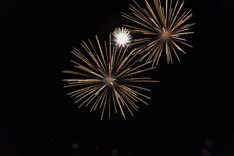 Low angle view of fireworks exploding against sky at night Stock Photos
