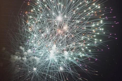 Low angle view of fireworks exploding against sky at night Stock Photos