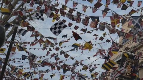 A low angle view of flags buntings on a street. Stock Footage 279937955