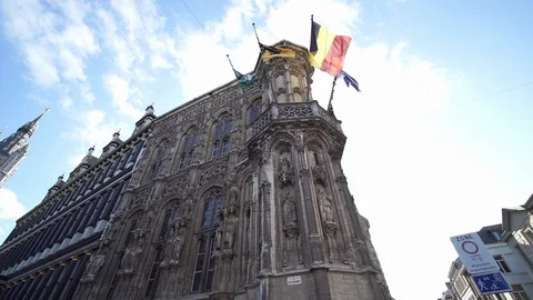 Low angle view of flags waving on Ghent City Hall building facade. (Flags of 스톡 동영상 103564094