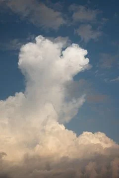 Low angle view of fluffy cumulus clouds against blue sky background. Beautiful Stock Photos