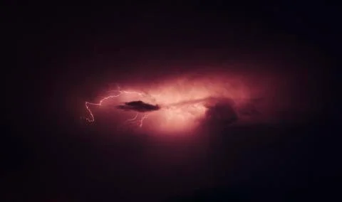 Low angle view of forked lightning against dramatic sky during night Stock Photos