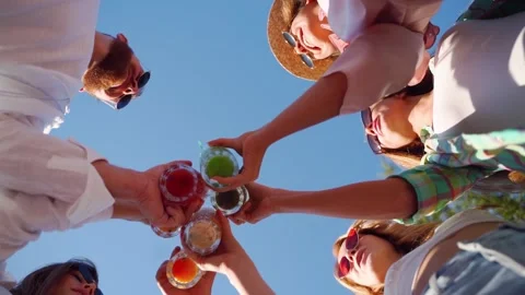 Low angle view of friends having fun at pool party, clinking glasses with Stock Footage 154102829