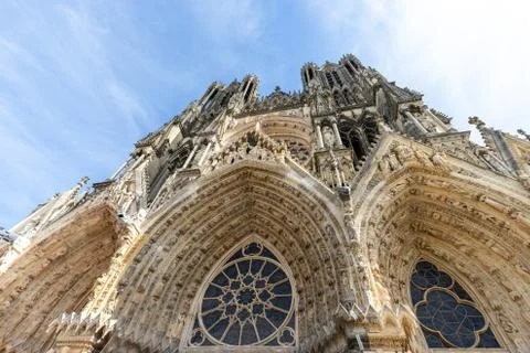 Low angle view at the front of cathedral Notre Dame in Reims Stock Photos