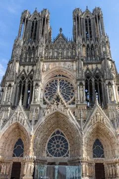 Low angle view at the front of cathedral Notre Dame in Reims Stock Photos