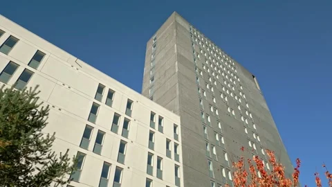 Low angle view of a generic nondescript unremarkablen grey skyscraper and a Stock Footage 303014067