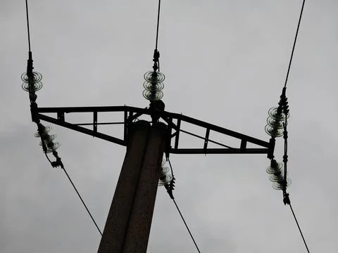 Low angle view of glass insulators on a concrete electricity pole Stock Photos