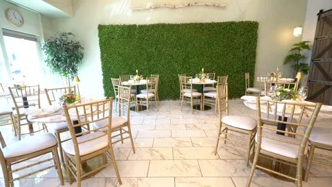 Low angle view of gold chairs and tables on a marble floor Stock Footage 345554269