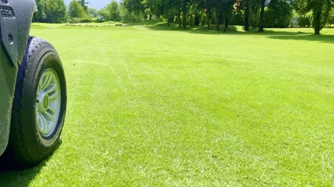 Low Angle View on a Golf Cart Travel on the Fairway on Golf Course 動画素材 245266807