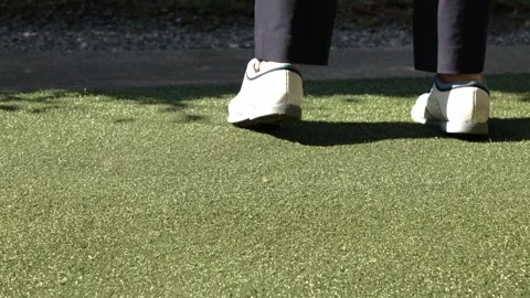 Low Angle View on Golf Shoes Moving then a Golfer Hitting with Her Golf Club Stockbeeldmateriaal 264756190