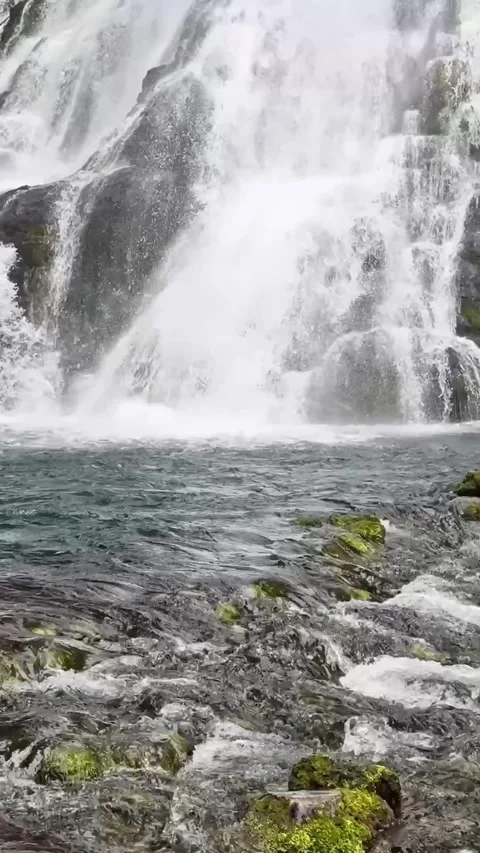 Low angle view at Golling Waterfall’s outflow, with foamy water rushing over Stock Footage 340138926