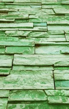 Low Angle View of Gradient Green Colored Rough Stone Blocked Wall Stock Photos