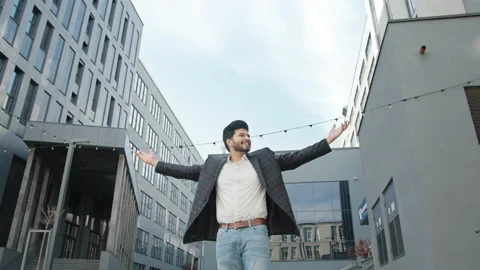 Low angle view of handsome hindu businessman standing near modern office Stock Footage 157277481