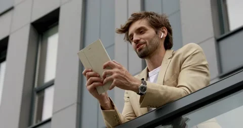 Low angle view of handsome man in business suit having video chat on digital Stock Footage 137743972