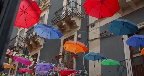 Low angle view of the hanging umbrellas of different colors in the street, 4k Video stock 332713591