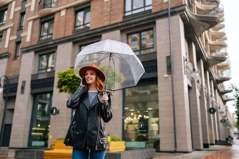 Low-angle view of happy young woman wearing elegant hat standing with Stock Photos