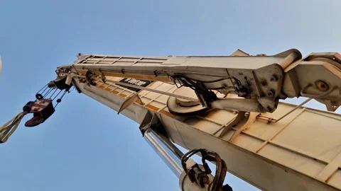 Low angle view of a heavy-duty telescopic boom crane and hydraulic cylinder Stock Footage 347513960