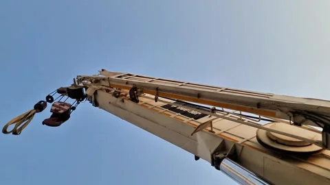 Low angle view of a heavy-duty hydraulic telescopic boom crane against Stock Footage 347513973
