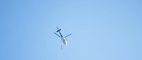 Low angle view of helicopter flying over the street name sign in city Video stock 103413531