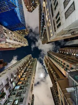 Low angle view of high buildings in Hong Kong at night. Stock Photos