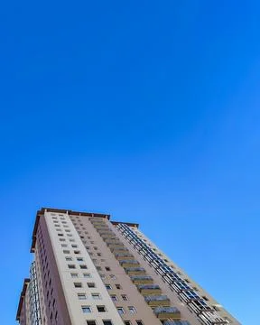Low angle view of high-rise apartment buildings rise to the sky. Stock Photos