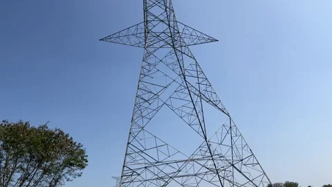 Low-angle view of a high-voltage steel power transmission tower Stock Footage 328505984