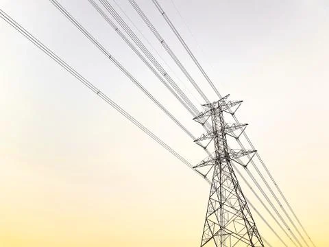 Low Angle View of High Voltage Tower and Power Lines at Sunset Stock Photos