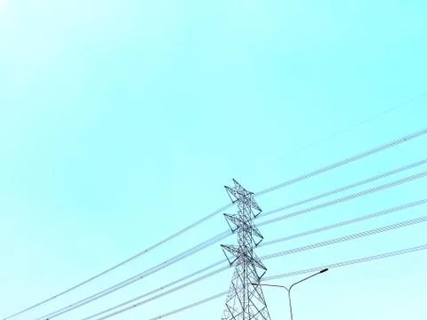 Low Angle View of High Voltage Towers and Power Lines Against Clear Blue Sky Stock Photos