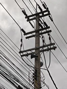 Low angle view of high voltage twisted aerial bundled cable termination. Stock Photos