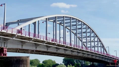 Low angle view highlights the intricate steel arch and truss structure of John Stock Footage 339836965