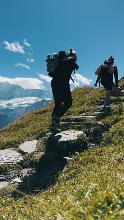 Low Angle View of Hikers Climbing Mountain Trail Stock Footage 329250537