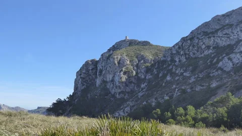 A low angle view of a hill with a lighthouse on its top. Stock Footage 122449978