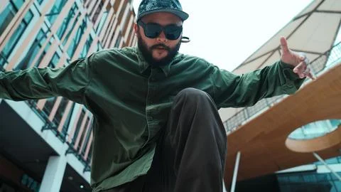 Low angle view of hipster pose in hip hop style surrounded by mall. Endeavor. Stock Photos