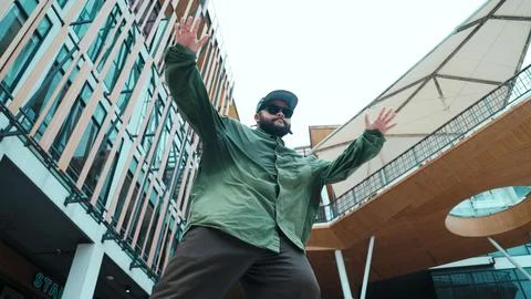 Low angle view of hipster pose in hip hop style surrounded by mall. Hiphop. 写真素材