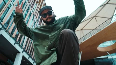 Low angle view of hipster pose in hip hop style surrounded by mall. Hiphop. Stock Photos